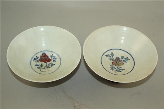 A pair of Chinese underglaze blue and copper red conical bowls, Jiajing marks, late 19th / early 20th century, 15.5cm, wood stand